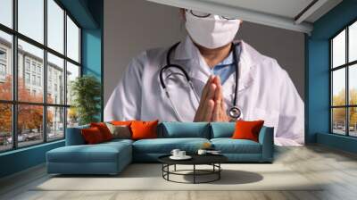 Doctor prays for the health of the person under their care, as medicine, nurses, and health care at the hospital work together to fight the disease. doctor, pray, health, person, medicine, care. Wall mural