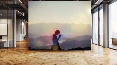 faith of christian concept: spiritual prayer hands over sun shine with blurred beautiful sunset back Wall mural