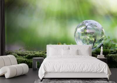 Globe planet glass In green forest with bokeh nature lights. world environment day. concept for environment conservation, protect ecology earth and environmental eco-friendly life with copy space Wall mural