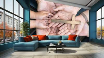 Group of Christian believers clasped hands in prayer, In the church, expressing their faith through worship and reverence for God, symbolized by the cross. Group christian pray concept. Wall mural