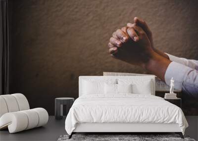 Hands folded in prayer on a Holy Bible in church concept for faith Wall mural