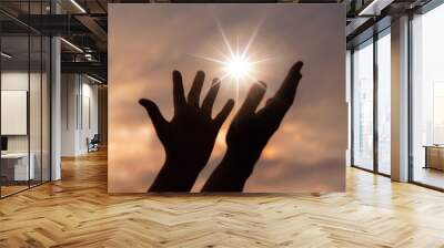 Person human hands open palm up worship or pray for god. background is sunrise. Concept for Christian, Christianity, Catholic religion, divine, heavenly, celestial or god. Wall mural