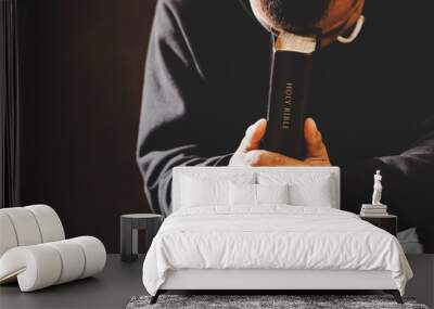 Portrait of a man praying with his eyes closed. Wall mural