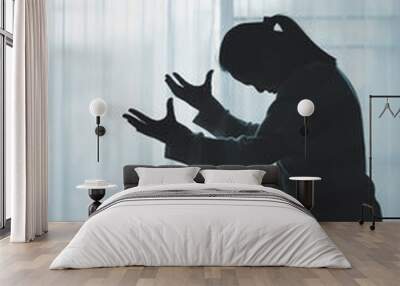 silhouette of woman kneeling and praying in modern church at sunset time. Female catholic prayer worship to God wish a better life in home at dawn with believe faith. concept of worshipers kneeling. Wall mural