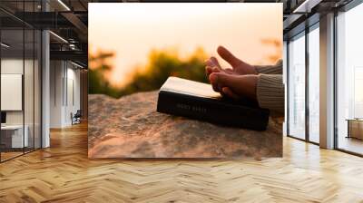 Silhouette of woman kneeling down praying for worship God at sky background. Christians pray to jesus christ for calmness. In morning people got to a quiet place and prayed. copy space. Wall mural