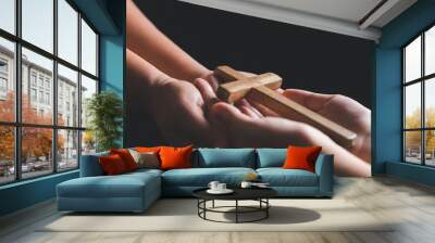 Woman's hand with cross. Concept of hope, faith, christianity, religion, church online. Person holding christian cross to making pray indoors. Believe and faith for christian people. Wall mural