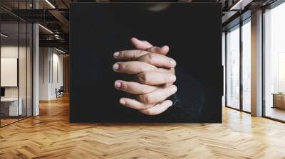 Woman praying on holy bible in the morning. Teenager woman hand with Cross and Bible praying, Hands folded in prayer on a Holy Bible in church concept for faith, spirituality and religion. Wall mural