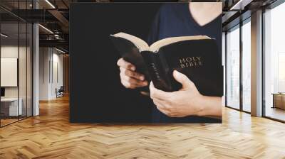 Young woman person hand holding holy bible with study at home. Adult female christian reading book in church. Girl learning religion spirituality with pray to god. concept of student education faith. Wall mural