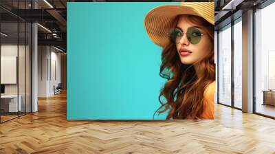 Fashion-forward female in sunglasses and a straw hat ready for summer adventures Wall mural