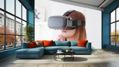 Young woman wearing virtual reality glasses at home. Wall mural