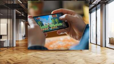 Person playing a retro-inspired mobile game with pixel graphics on a smartphone screen. Wall mural