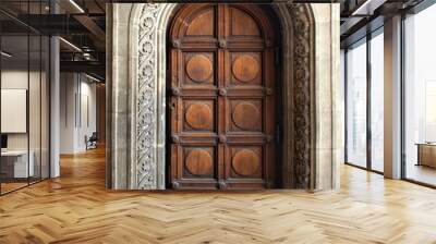 big beautiful ornate wooden door, framed by a decorated stone arch - entrance to a gothic cathedral or castle Wall mural