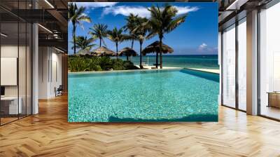 Pool, umbrella and luxury Caribbean resort hotel, with a fine white sandy beach and crystal clear turquoise sea ideal for summer vacations and relaxation. Wall mural