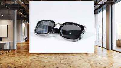 Stylish sunglasses with a black frame on a white background Wall mural