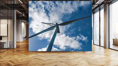 Modern windmill framed by the puffy clouds and blue sky in the Netherlands Wall mural