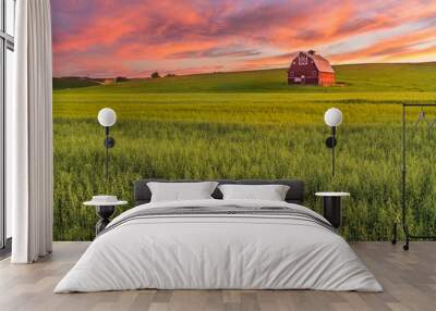 Red barn in wheat field in Palouse region of Southeast Washington State with a vibrant sunset  Wall mural