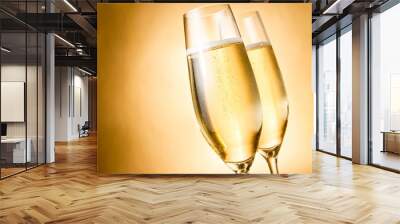 two glasses of champagne with golden bubbles and space for text Wall mural