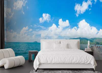 Panoramic coastal Con Dao view from above, with waves, coastline ,clear sky and road, blue sea and mountain. Wall mural