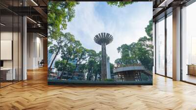 Wide angle view of Lotus pillar - An iconic architecture at Turtle lake (Ho Con Rua) with blue sky in Saigon. Wall mural