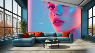 beautiful woman's face on a stylish neon pink and pastel blue background. Wall mural