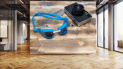 retro camera on a wooden table and swimming goggles Wall mural