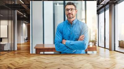 Setting the bar as a leader. Portrait of a mature businessman standing in an office. Wall mural