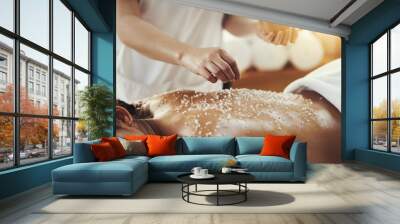 Woman, hands and salt in massage at spa for skincare, exfoliation or body treatment at resort. Hand of masseuse applying salts to back skin for relaxation, therapy or zen in healthy wellness at salon Wall mural