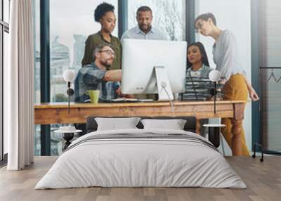 Working together to get the task done. Shot of businesspeople working together in the office. Wall mural