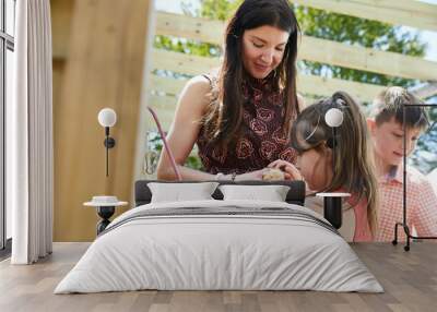 A mother and daughter share excitement at the new baby chicks for eggs they are adding to their backyard chicken coup. Wall mural