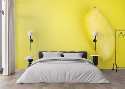 Fresh ripe juicy mango on a yellow background Wall mural