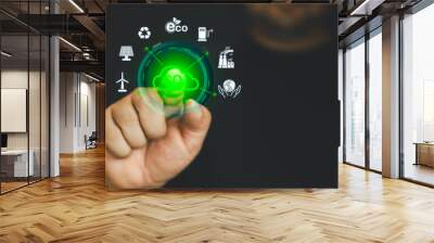 Hand points to a touchscreen CO2 icons and an icon renewable energy for reduce CO2 emission on virtual screen, net zero carbon, global warming, green fuel and earth protect Wall mural