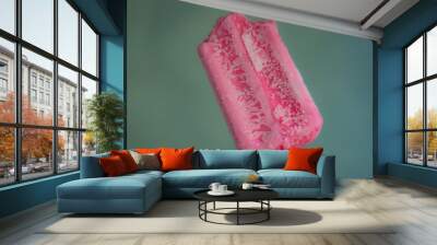 Holding delicious strawberry popsicle with a bite Wall mural