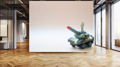 Miniature people standing on miniature military army vehicle tank Wall mural