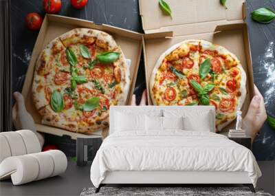 Hands hold boxes with tasty pizza, top view Wall mural