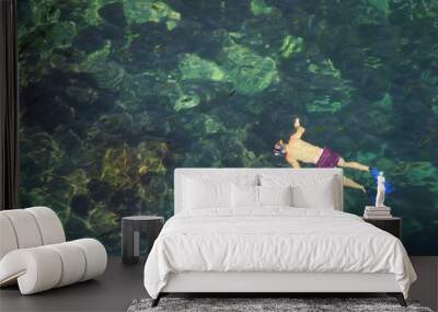 Man snorkeling in clear water Wall mural