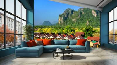 Row of tourist bungalows along Nam Song River in Vang Vieng, Vie Wall mural