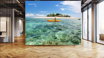 Young woman kayaking near South Sea Island, Mamanuca islands group, Fiji Wall mural