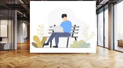 Man using laptop computer on street bench. Wall mural