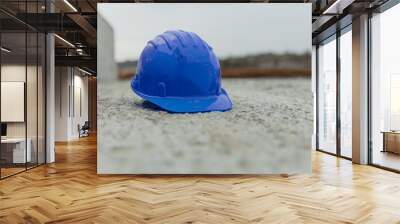 Closeup shot of a blue construction helmet on concrete Wall mural