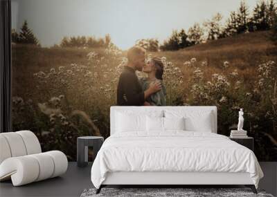 Young couple in love having fun and enjoying the beautiful nature Wall mural