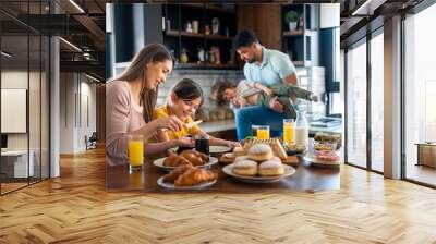 Family meal at home. Young parents with small children having fun during breakfast. Wall mural