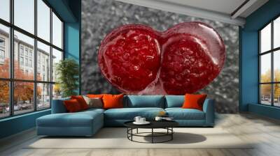 heart shaped ice cube with raspberries trapped inside, macro shot, isolated on dark textured background Wall mural