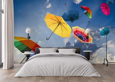 Windiger Herbsttag mit bunten Regenschirmen Wall mural