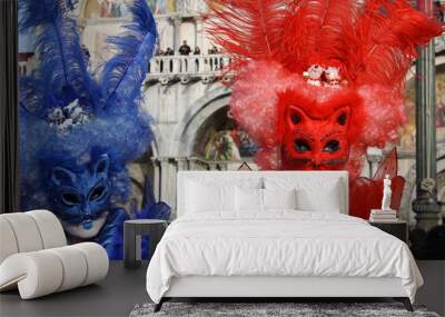 italy, carnival masks in venice posing in san marco square. Two colored cats, red and blue Wall mural