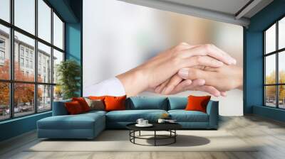 female doctor hand comforting patient with blur background of hospital room Wall mural