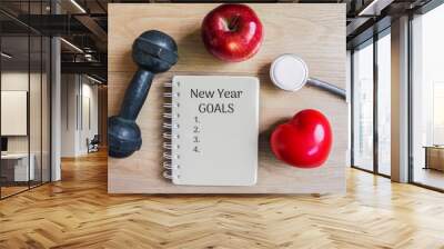 new year goals for sport concept with red apple,dumbbell,heart shape and resolution list on notebook  Wall mural