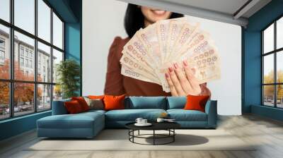 successful Asian woman hand showing Thai money banknotes ,investment and earning conce Wall mural