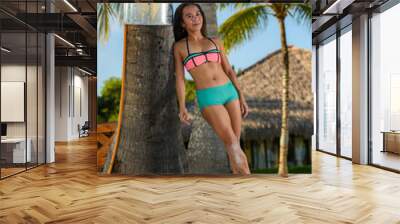 Filipino girl in bikini lounging and posing at tropical beach Wall mural