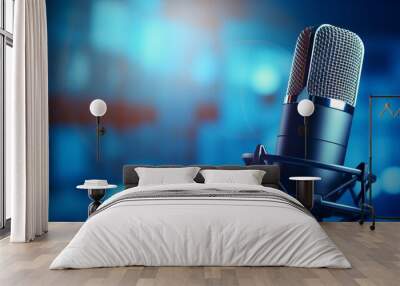 A studio microphone with mesh design, capturing clarity in sound, stands in sharp focus against a backdrop of blue backlighting, offering ample copy space. Wall mural