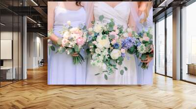 Bride and bridesmaids in lavender dresses in a summertime wedding bouquets with white, pink, and purple flowers and green leaves. Wall mural